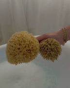 working up a rich lather with a natural sea sponge over a bath